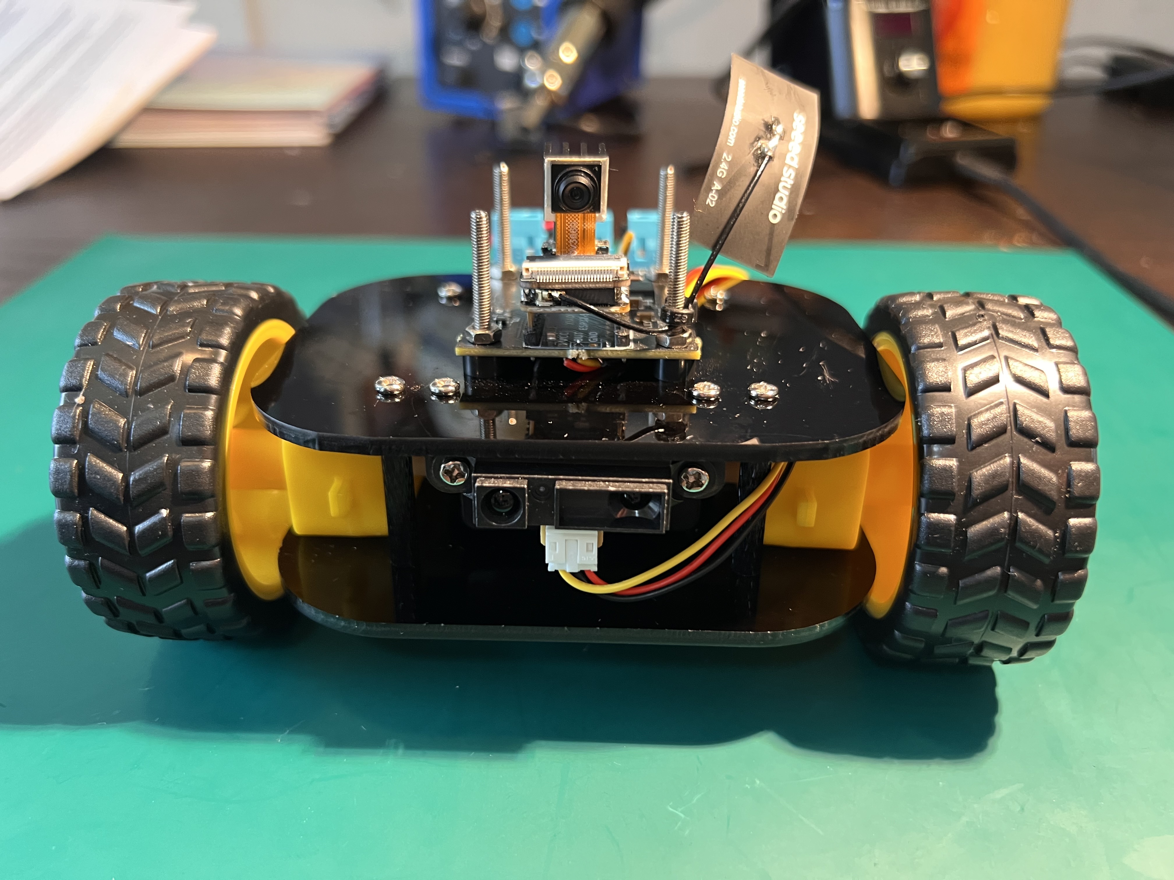 The Plexus robot — a small two-wheeled platform with a camera module, battery pack, and custom PCB enclosed in laser-cut acrylic plates.